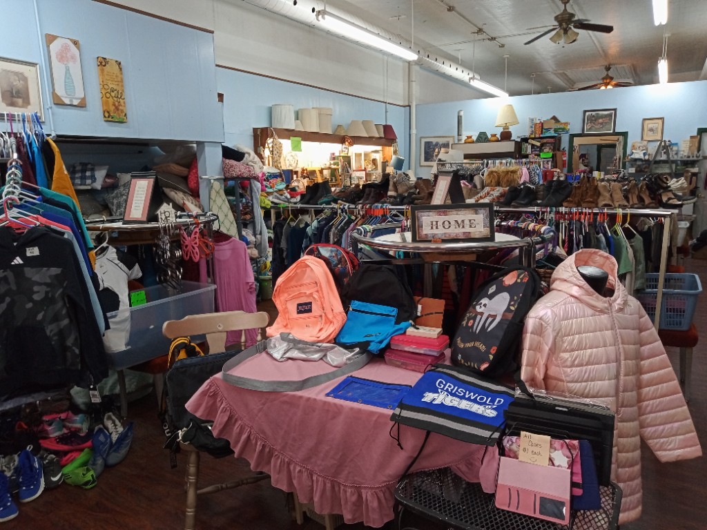 Back to school clothing, backpacks, and gear displayed inside The Lord’s Closet